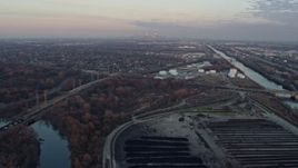 4K aerial stock footage tilt from Des Plaines River to reveal Chicago skyline at sunset in Forest View, Illinois Aerial Stock Footage | AX0163_0016