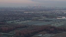 4K aerial stock footage tilt from homes to reveal Chicago skyline at sunset in Forest View, Illinois Aerial Stock Footage | AX0163_0017