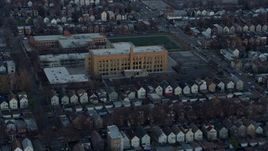 4K aerial stock footage of approaching elementary schools at sunset in West Side Chicago, Illinois Aerial Stock Footage | AX0163_0020