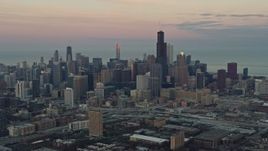 4K aerial stock footage of approaching the Downtown Chicago skyline at sunset from the West Side, Illinois Aerial Stock Footage | AX0163_0025