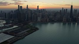 4K aerial stock footage of approaching the city skyline at sunset, Downtown Chicago, Illinois Aerial Stock Footage | AX0163_0035