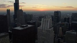4K aerial stock footage of flying over skyscrapers toward the light of the sunset, Downtown Chicago, Illinois Aerial Stock Footage | AX0163_0038