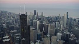 4K aerial stock footage of passing Willis Tower for a view of skyscrapers at twilight, Downtown Chicago, Illinois Aerial Stock Footage | AX0163_0039