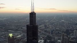 4K aerial stock footage of orbiting the top of Willis Tower at twilight, Downtown Chicago, Illinois Aerial Stock Footage | AX0163_0040
