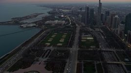 4K aerial stock footage of Grant Park and the Field Museum from Lake Michigan at twilight, Downtown Chicago, Illinois Aerial Stock Footage | AX0163_0043