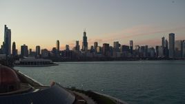 4K aerial stock footage flyby Adler Planetarium, reveal and approach city skyline at twilight, Downtown Chicago, Illinois Aerial Stock Footage | AX0163_0047