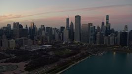 4K aerial stock footage approach skyscrapers bordering Grant Park at twilight, Downtown Chicago, Illinois Aerial Stock Footage | AX0163_0048