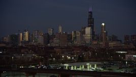4K aerial stock footage of the city's skyline seen while descending at twilight, Downtown Chicago, Illinois Aerial Stock Footage | AX0163_0056