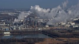 4K aerial stock footage of flying by an oil refinery in Romeoville, Illinois Aerial Stock Footage | AX0165_0001