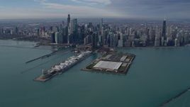 4K aerial stock footage of flying by tall, waterfront skyscrapers and Navy Pier in Downtown Chicago, Illinois Aerial Stock Footage | AX0165_0034