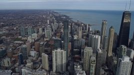 4K aerial stock footage of following State Street past Downtown Chicago skyscrapers, Illinois Aerial Stock Footage | AX0165_0053