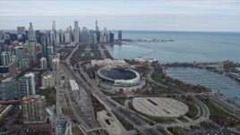 4K aerial stock footage of flying by Soldier Field football stadium, reveal Downtown Chicago skyline, Illinois Aerial Stock Footage | AX0165_0061