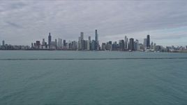 4K aerial stock footage of the Downtown Chicago skyline seen from Lake Michigan breakwater, Illinois Aerial Stock Footage | AX0165_0070