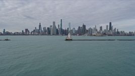 4K aerial stock footage fly over lighthouse to approach the Downtown Chicago skyline, Illinois Aerial Stock Footage | AX0165_0071