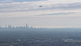 4K aerial stock footage of tracking a commercial jet, downtown skyline in background, Chicago, Illinois Aerial Stock Footage | AX0166_0016