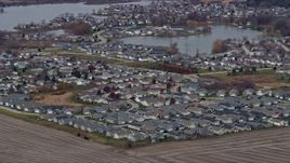 4K aerial stock footage of flying by a suburban neighborhood by a lake in Grayslake, Illinois Aerial Stock Footage | AX0166_0038