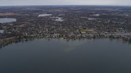 4K aerial stock footage of flying past lakeside homes in Lindenhurst, Illinois Aerial Stock Footage | AX0166_0042