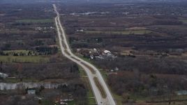 4K aerial stock footage of passing a country road and barns in Bristol, Wisconsin Aerial Stock Footage | AX0166_0048