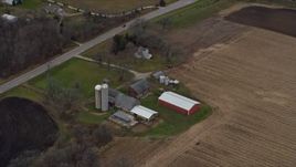 4K aerial stock footage of flying past a barn, silos and farmhouse in Bristol, Wisconsin Aerial Stock Footage | AX0166_0050