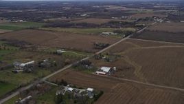 4K aerial stock footage of passing farms around a country road in Union Grove, Wisconsin Aerial Stock Footage | AX0166_0051