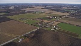 4K aerial stock footage of passing farms and fields beside a country road in Union Grove, Wisconsin Aerial Stock Footage | AX0166_0052