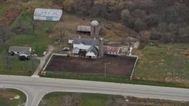4K aerial stock footage of flying past a barn, silos and farmhouse in Union Grove, Wisconsin Aerial Stock Footage | AX0166_0054