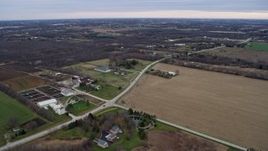 4K aerial stock footage of flying past farms and fields in Franksville, Wisconsin Aerial Stock Footage | AX0167_0038