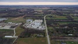 4K aerial stock footage of flying over a manufacturing plant, fields and farms in Franksville, Wisconsin Aerial Stock Footage | AX0167_0041