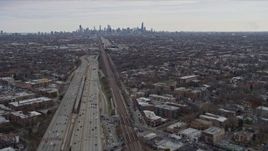 4K aerial stock footage of tilting from light freeway traffic to reveal wide view of Downtown Chicago skyline, Illinois Aerial Stock Footage | AX0167_0077