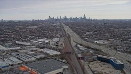 4K aerial stock footage of following light freeway traffic, tilt to reveal wide view of Downtown Chicago skyline, Illinois Aerial Stock Footage | AX0167_0078