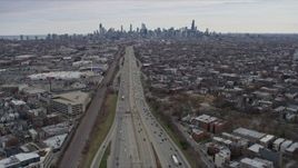 4K aerial stock footage of light freeway traffic, tilt to reveal the Downtown Chicago skyline, Illinois Aerial Stock Footage | AX0167_0080