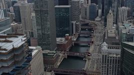 4K aerial stock footage of flying by skyscraper under construction to reveal the Chicago River in Downtown Chicago, Illinois Aerial Stock Footage | AX0167_0086