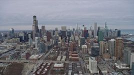 4K aerial stock footage of flying away from skyscrapers and city buildings in Downtown Chicago, Illinois Aerial Stock Footage | AX0167_0090