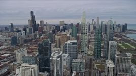 4K aerial stock footage of flying past skyscrapers and city buildings, reveal Grant Park in Downtown Chicago, Illinois Aerial Stock Footage | AX0167_0091
