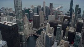 4K aerial stock footage of waterfront skyscrapers by the Chicago River, Downtown Chicago, Illinois Aerial Stock Footage | AX0167_0099