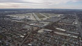 4K aerial stock footage approaching the runways and commercial planes at terminals at Chicago Midway International Airport, Illinois Aerial Stock Footage | AX0168_0010