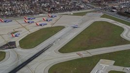 4K aerial stock footage a commercial jet racing down the runway at Chicago Midway International Airport, Illinois Aerial Stock Footage | AX0168_0011