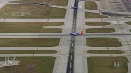 4K aerial stock footage a commercial jet lifting off from Chicago Midway International Airport, Illinois Aerial Stock Footage | AX0168_0012