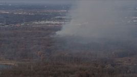 4K aerial stock footage of smoke rising from a fire in the woods, Willow Springs, Illinois Aerial Stock Footage | AX0168_0020