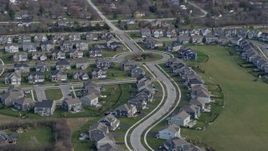 4K aerial stock footage of a reverse view of tract homes in a suburban neighborhood in Lemont, Illinois Aerial Stock Footage | AX0168_0026