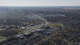 4K aerial stock footage of a strip mall and upscale homes near 19th Street, smoke rising from trees, in Lockport, Illinois Aerial Stock Footage | AX0168_0028