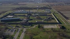 4K aerial stock footage of circling around and flying away from Stateville Correctional Center in Crest Hill, Illinois Aerial Stock Footage | AX0168_0042