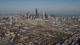4K aerial stock footage tilt from West Side Chicago urban neighborhoods to reveal the Downtown Chicago skyline, Illinois Aerial Stock Footage | AX0169_0022