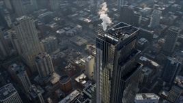 4K aerial stock footage of flying around the top of the One Chicago skyscraper, Downtown Chicago, Illinois Aerial Stock Footage | AX0169_0067
