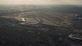 4K aerial stock footage of approaching Chicago Midway International Airport at sunset, Illinois Aerial Stock Footage | AX0169_0105