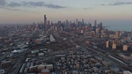 4K aerial stock footage wide view of the Downtown Chicago skyline seen from South Side Chicago neighborhoods at sunset, Illinois Aerial Stock Footage | AX0170_0010