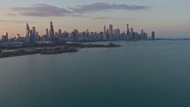 4K aerial stock footage of the Downtown Chicago skyline, seen from Lake Michigan at sunset, Illinois Aerial Stock Footage | AX0170_0012