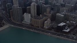 4K aerial stock footage a reverse view of skyscrapers and Lake Shore Drive at sunset in Downtown Chicago, Illinois Aerial Stock Footage | AX0170_0029