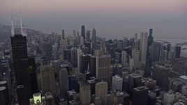 4K aerial stock footage of flying past downtown's tall skyscrapers at sunset, Downtown Chicago, Illinois Aerial Stock Footage | AX0170_0034