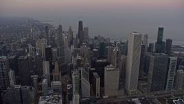 4K aerial stock footage passing downtown's tall skyscrapers at sunset, Downtown Chicago, Illinois Aerial Stock Footage | AX0170_0036